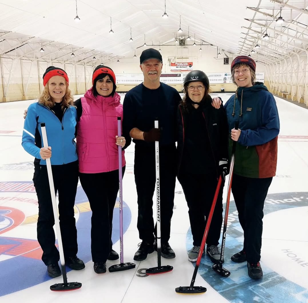 4 curling people shoulder to shoulder